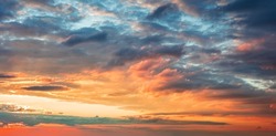 Dramatic sunrise sundown sky background with colorful clouds without birds. Panoramic sky background