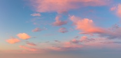Pastel light cirrus clouds in the blue sky during dawn sunset sunrise, sky background