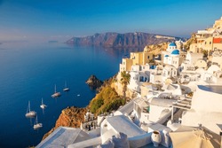 Famous Panoramic view of Santorini, Greece. White architecture, yachts and the blue sea of the island of Santorini against the background of the sea. Holidays in Greece, Santorini.