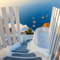 Gate to heaven. Santorini, Greece. White architecture, open doors and steps to the blue sea of Santorini. Holidays in Greece, Santorini.