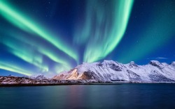 Aurora Borealis, Lofoten islands, Norway. Nothen light, mountains and ocean. Winter landscape at the night time. Norway travel - image