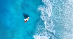 Wave and boat on the beach as a background. Beach and waves from top view. Turquoise water background from top view. Top view from drone. Travel - image