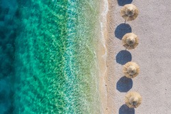 Mediterranean sea. Aerial view on the beach and umbrellas. Vacation and adventure. Coast and blue water. Top view from drone at beach and azure sea. Travel and vacation image.