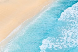 Travel and vacation image. Beach. Seascape. Coast as a background from top view. Blue water background from air. Strong waves.