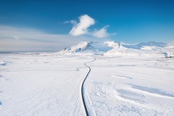 Iceland. Aerial view of the road. Winter landscape from a drone. Traveling along the Golden Ring in Iceland by car.