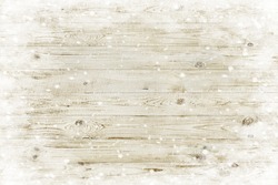 The brown wood texture with snow flakes over it. Winter background