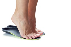 female feet stand on their toes in orthopedic insoles