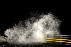 Stormy weather and breaking waves at night