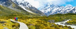 Tourists hiking on Hooker Valley Track in Mount Cook National Park, New Zealand. 