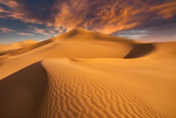 Sunset over the sand dunes in the desert. Aerial view