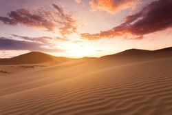 Beautiful sunset in the Sahara desert. Sand dunes at sunset