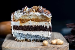 multi-layer cake with different layers, caramel, poppy seeds and cream layers of cake for dessert with nuts