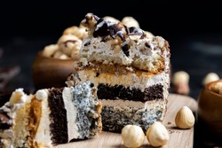 multi-layer cake with different layers, caramel, poppy seeds and cream layers of cake for dessert with nuts