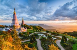 Landscape of two pagoda in Doi Inthanon Mountain with evening orange light splashed at the pagoda in sunset, Chaingmai, Thailand