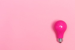 Colored light bulb on vivid colored background