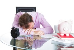 A close-up portrait of a businessman, corporate worker who fell asleep being exhausted working on his project whole day, isolated on a white background. Work place, desk, station.