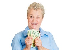 Closeup portrait super happy excited successful senior woman lady holding money dollar bills in hand, isolated white background. Positive emotions, facial expression, feeling. Financial reward savings
