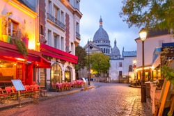 The Place du Tertre with tables of cafe and the Sacre-Coeur in the morning, quarter Montmartre in Paris, France