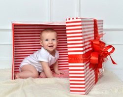 Infant child baby toddler kid sitting in presents gift for celebration. Christmas new year concept. 