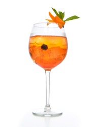 Orange margarita cocktail with fruits and vodka with crushed ice green mint in big wine glass on white background