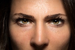 Beautiful and powerful intense staring eyes of confidence and courage in female close up