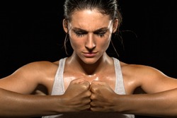 Mixed martial arts fighter woman gym athlete close up focused meditating conceptual
