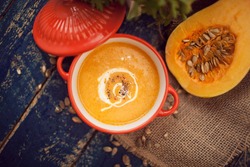 Pumpkin soup on wooden background