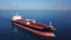  Aerial shot of red deck tanker ship sailing on open sea 