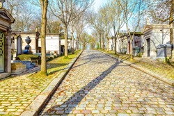 Path in cemetery . Pere Lachaise Cemetery . Pavement and crypts in the graveyard . Famous cemetry in Paris 