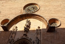 Church portal with rose windows . Sculptures at cathedral entrance . Catedral de Mallorca