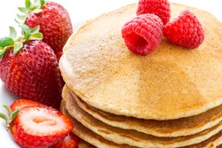 Stack of whole grains pancakes with fruits