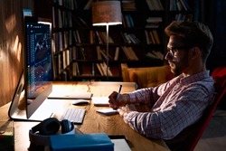 Focused business man trader analyst looking at computer monitor, investor broker analyzing indexes, financial chart trading online investment data on cryptocurrency stock market graph on pc screen.