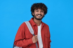 Smiling young curly bearded indian cool positive guy holding backpack standing isolated on blue background. Happy ethnic man university student with bag advertising education course, portrait.