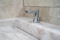 Non-contact, infrared sink faucet. plumbing for bathrooms and public restrooms. classic interior and modern details.