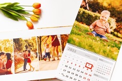 calendar with a photo of the boy and a photobook from a family photo shoot. a memorable gift. printed materials after the photo shoot. services of a professional photographer and printing.