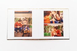 pages of a photobook from a family photo shoot. a memorable gift. printed materials after the photo shoot. services of a professional photographer and printing.