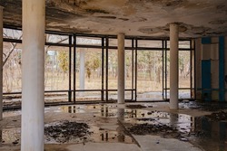 an old abandoned and ruined building with a wet ceiling and puddles on the floor. destruction, poverty and war. rehabilitation and reconstruction of premises.