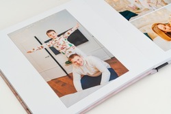 page with father and son. a Photobook of family at home on a white background. Photobook is gift. professional photographer and designer. printing of photos and journals in photo laboratory