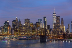Brooklyn park, Brooklyn Bridge, Janes Carousel and Lower Manhattan skyline at night seen from Manhattan bridge, New York city, USA.