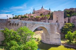 Panorama of the alcazar above the medieval San Martin bridge - Toledo, Spain