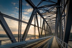 Inside view of big steel railway bridge on sunrise. Savonlinna, Finland
