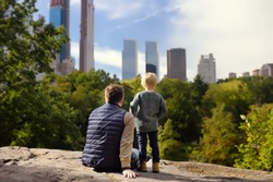 Man and his charming little son admire the views in Central Park, New York. Quality family time.