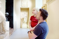 Little boy with his father looking at sculptures. Aesthetic and art education of kids.