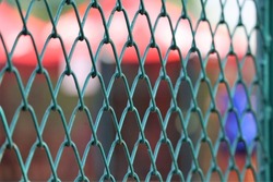 Green metal mesh fence of tennis hard court