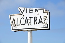 A broken old and abandoned sea-side neon sign that reads View Alcatraz. Located along the waterfront in San Francisco.