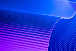 Pink and blue illuminated corrugated shapes. Geometric abstract background.