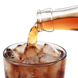 Cola is pouring from a bottle into a glass, isolated on white