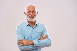 Portrait of cheerful senior man who is looking at camera and smiling.