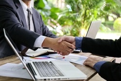 businessman hand hold together,Business handshake and business people. Business handshake for closing the deal after singing the lucrative contract between companies.Trust business partner 