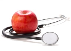 Closeup of apple and stethoscope, concept of healthy eating or lifestyle